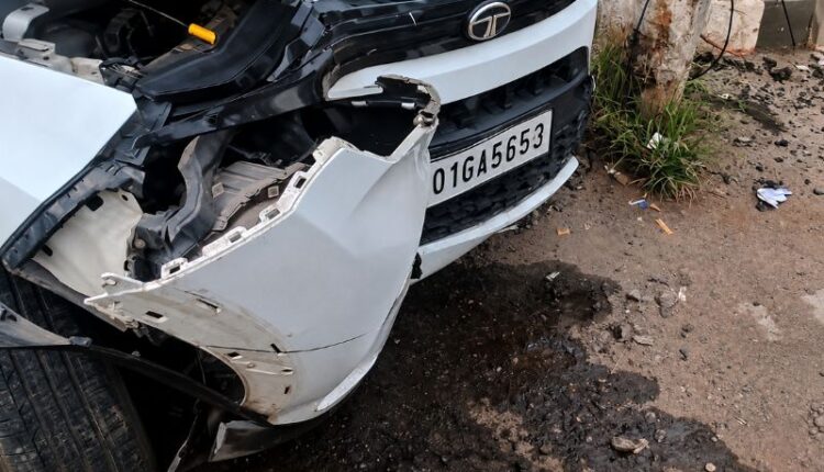 A damaged Tata Nexon stands beside an electricity pole after a road accident at Birubari in Guwahati involving three Royal Global University students.
